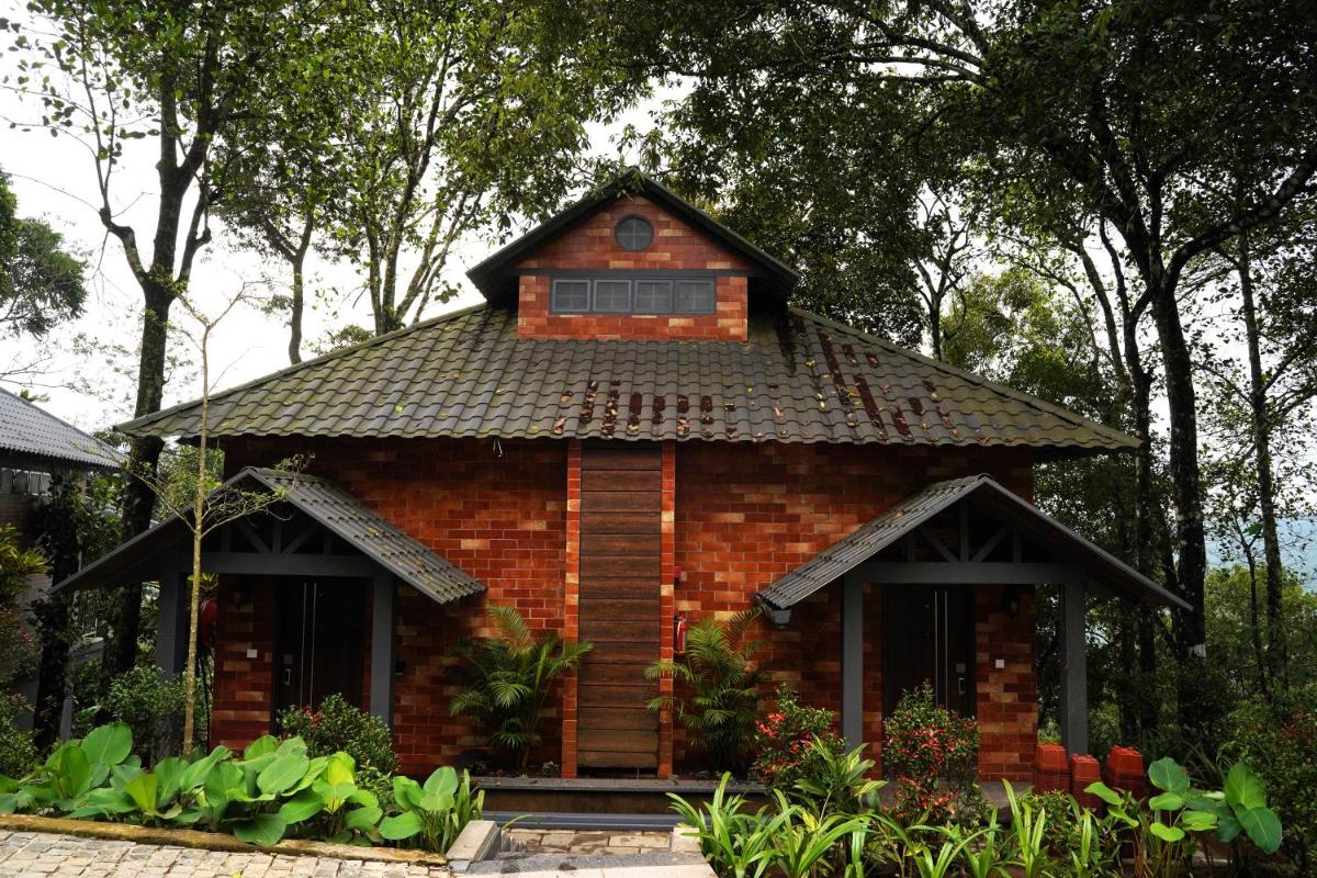 a small brick house with a roof at Elephant Passage in Munnar
