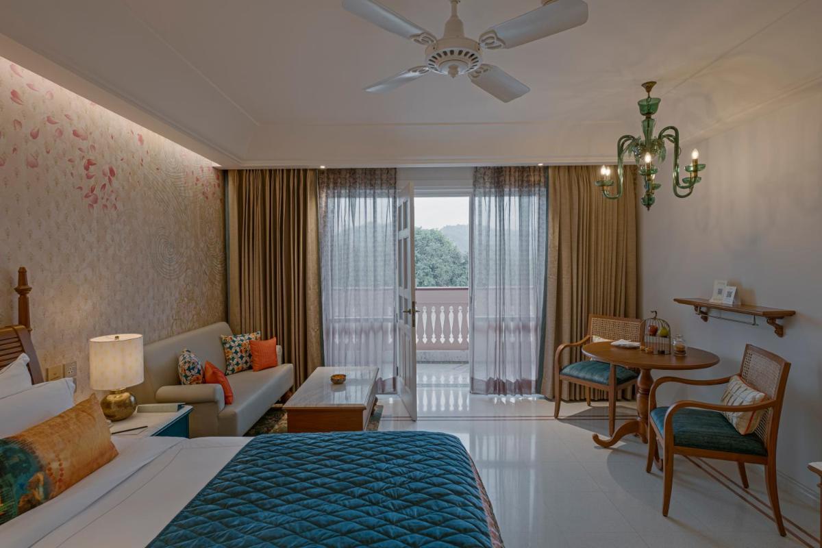 a bedroom with a bed and a living room at Pilibhit House, Haridwar – IHCL SeleQtions in Haridwār +48 photos