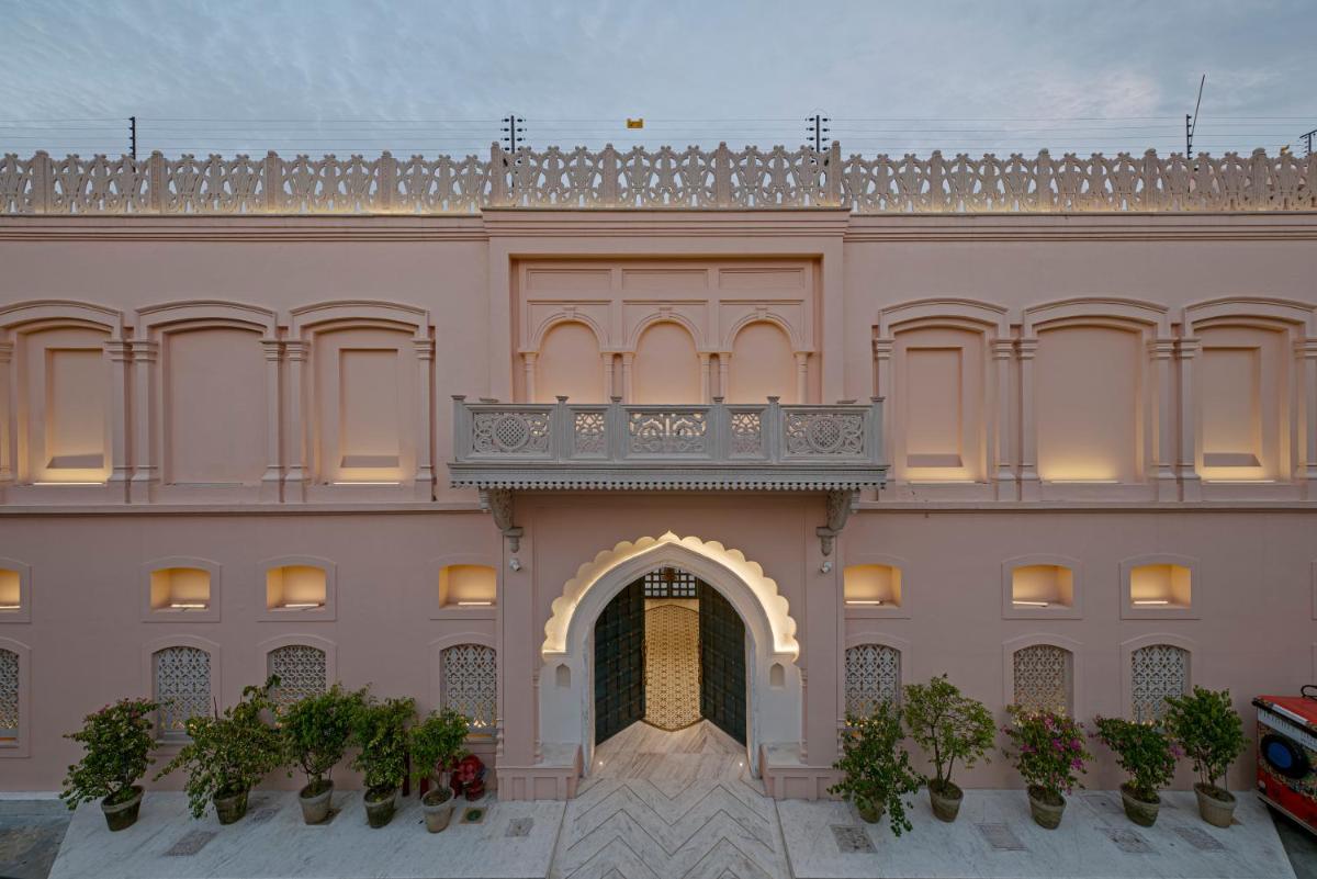 a large pink building with a balcony on top of it at Pilibhit House, Haridwar – IHCL SeleQtions in Haridwār