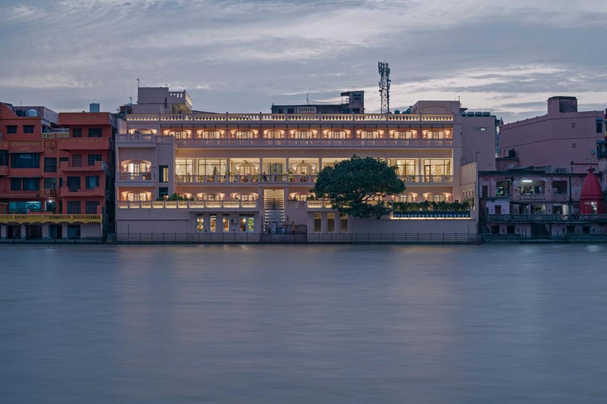 a large building next to a body of water at Pilibhit House, Haridwar – IHCL SeleQtions in Haridwār