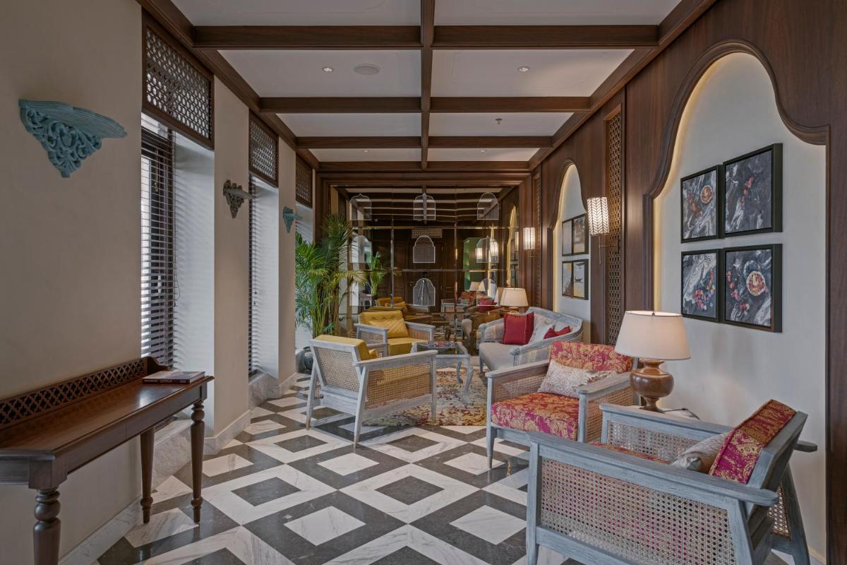 a hallway with chairs and a living room at Pilibhit House, Haridwar – IHCL SeleQtions in Haridwār
