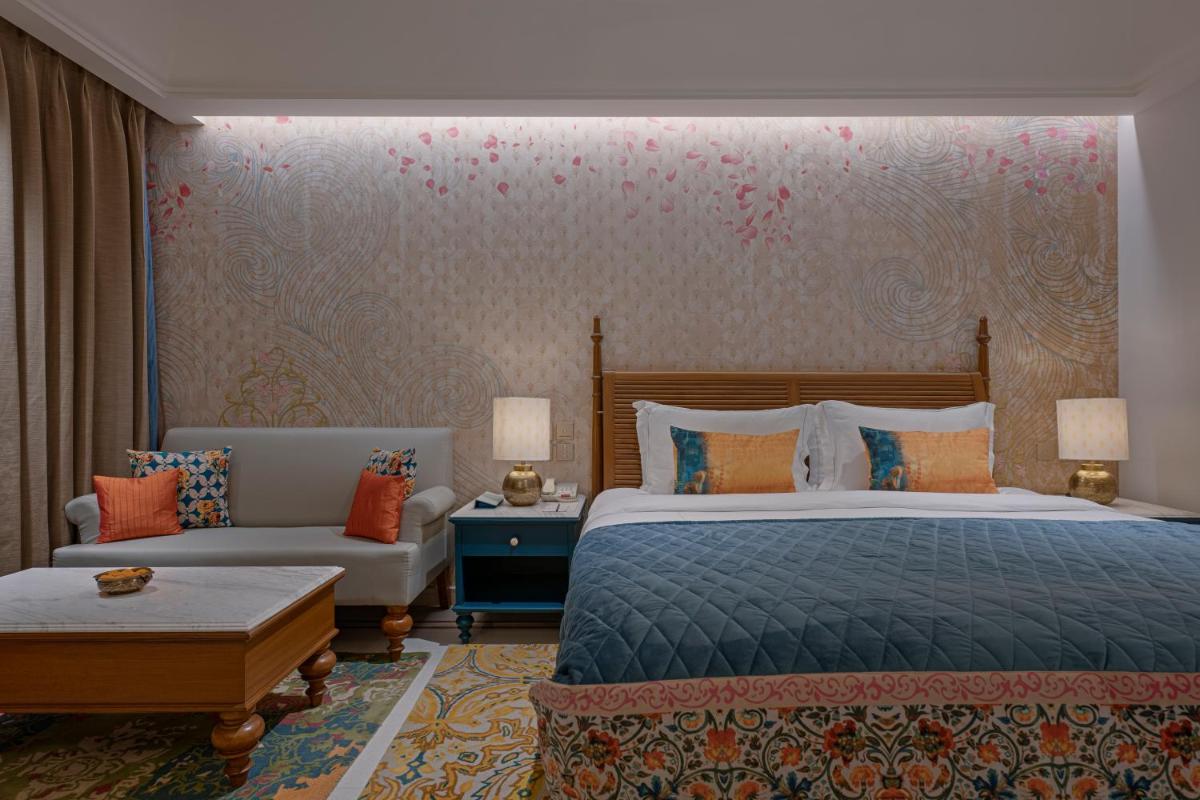 a hotel room with a bed and a couch at Pilibhit House, Haridwar – IHCL SeleQtions in Haridwār