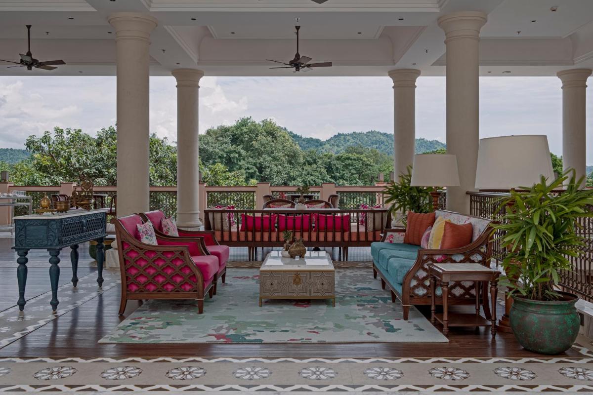 a living room with chairs and a table on a porch at Pilibhit House, Haridwar – IHCL SeleQtions in Haridwār