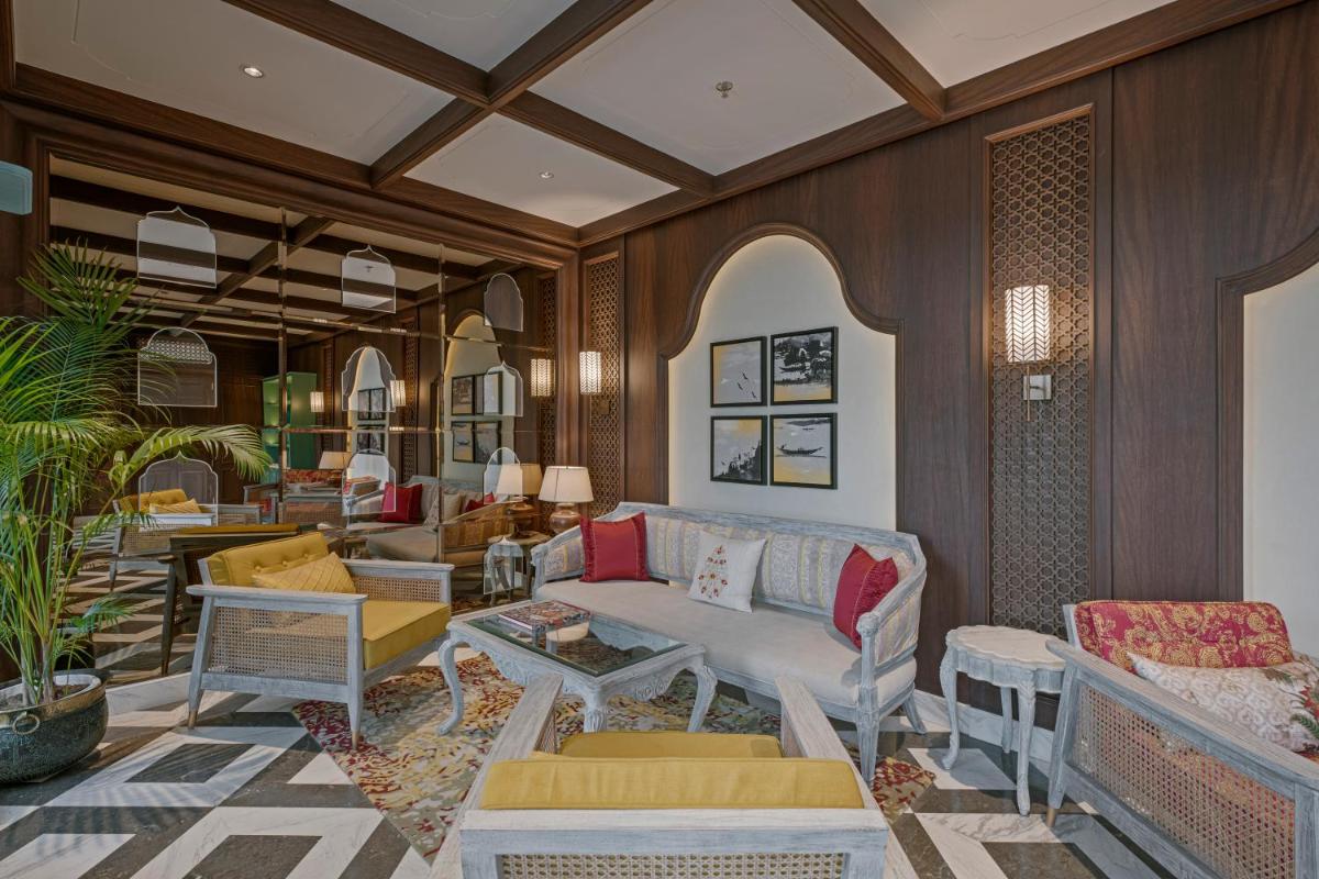 a living room with a couch and chairs at Pilibhit House, Haridwar – IHCL SeleQtions in Haridwār