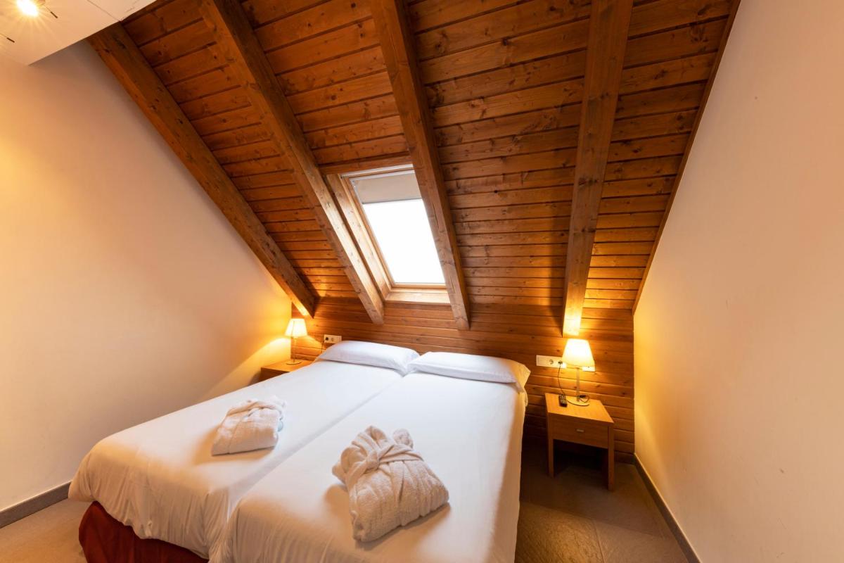 Cama o camas de una habitación en Aparthotel Trainera