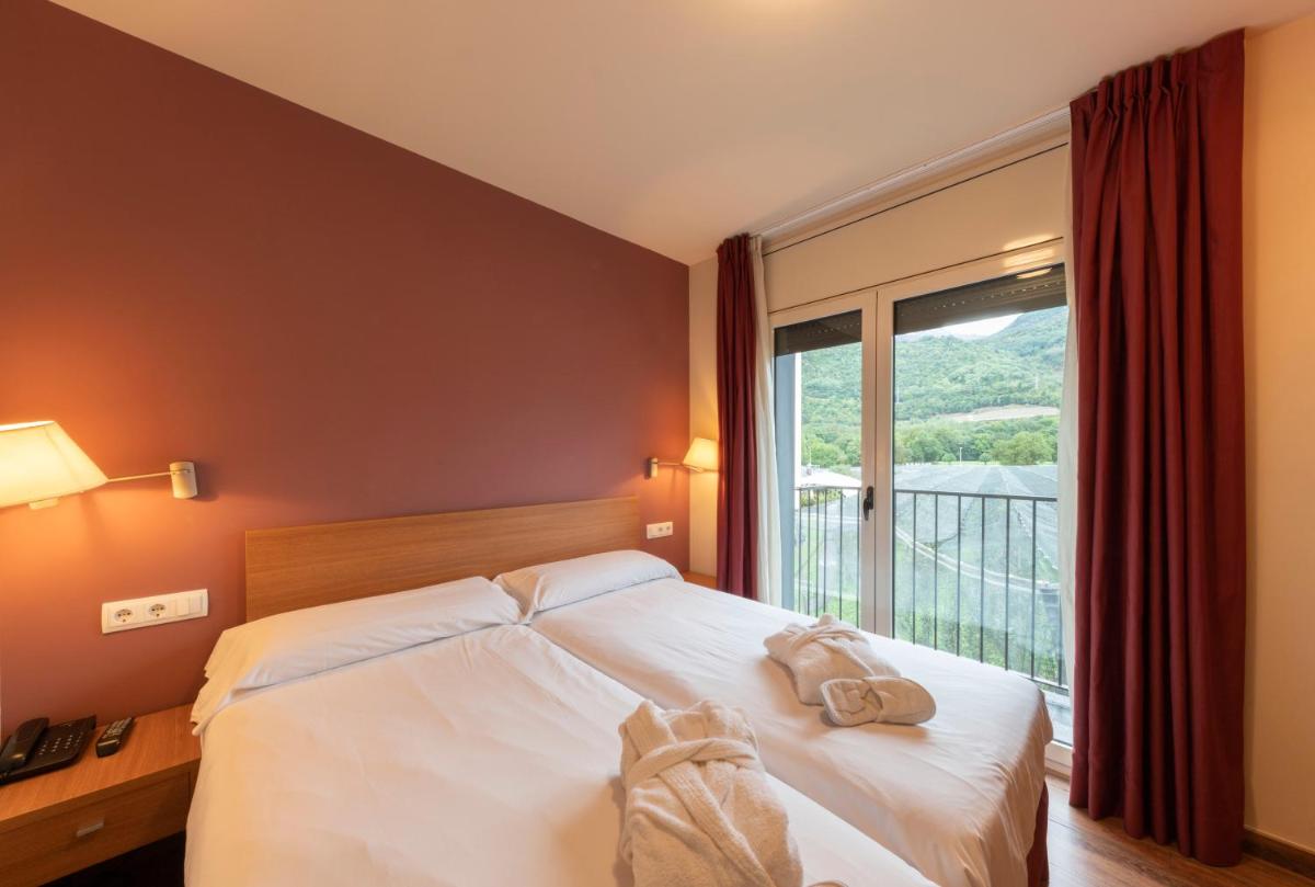 Cama o camas de una habitación en Aparthotel Trainera