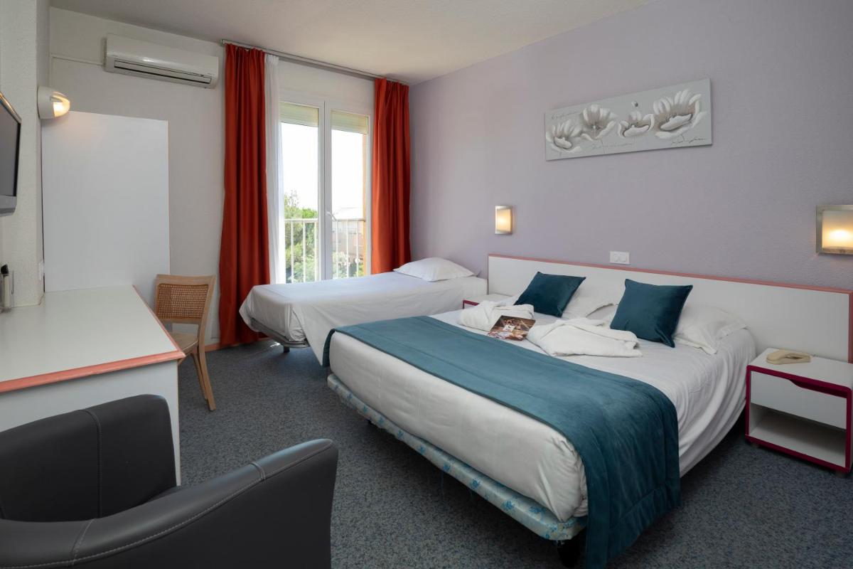 Un ou plusieurs lits dans un hébergement de l'établissement Relax'Otel & Spa, Le Barcarès