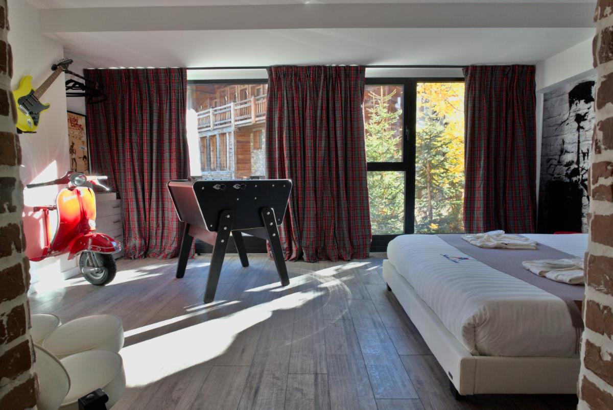 Un ou plusieurs lits dans un hébergement de l'établissement Snow Lodge Hotel Courchevel 1850