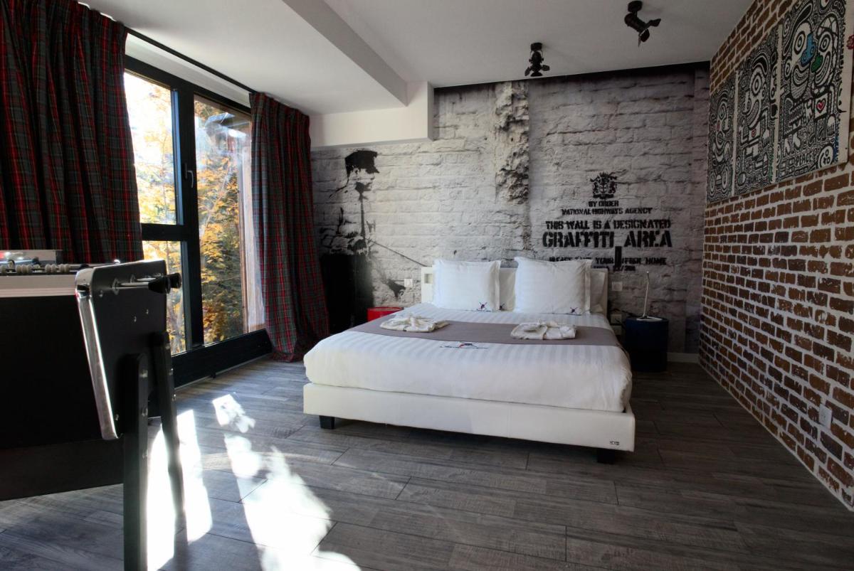 Un ou plusieurs lits dans un hébergement de l'établissement Snow Lodge Hotel Courchevel 1850