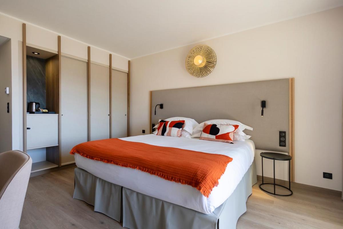Un ou plusieurs lits dans un hébergement de l'établissement Hotel L'Acquale