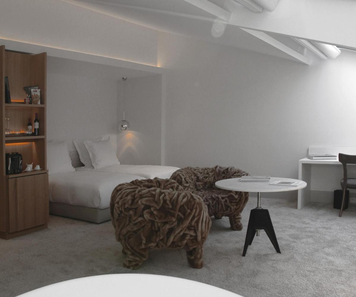 Un ou plusieurs lits dans un hébergement de l'établissement Yndo Hôtel