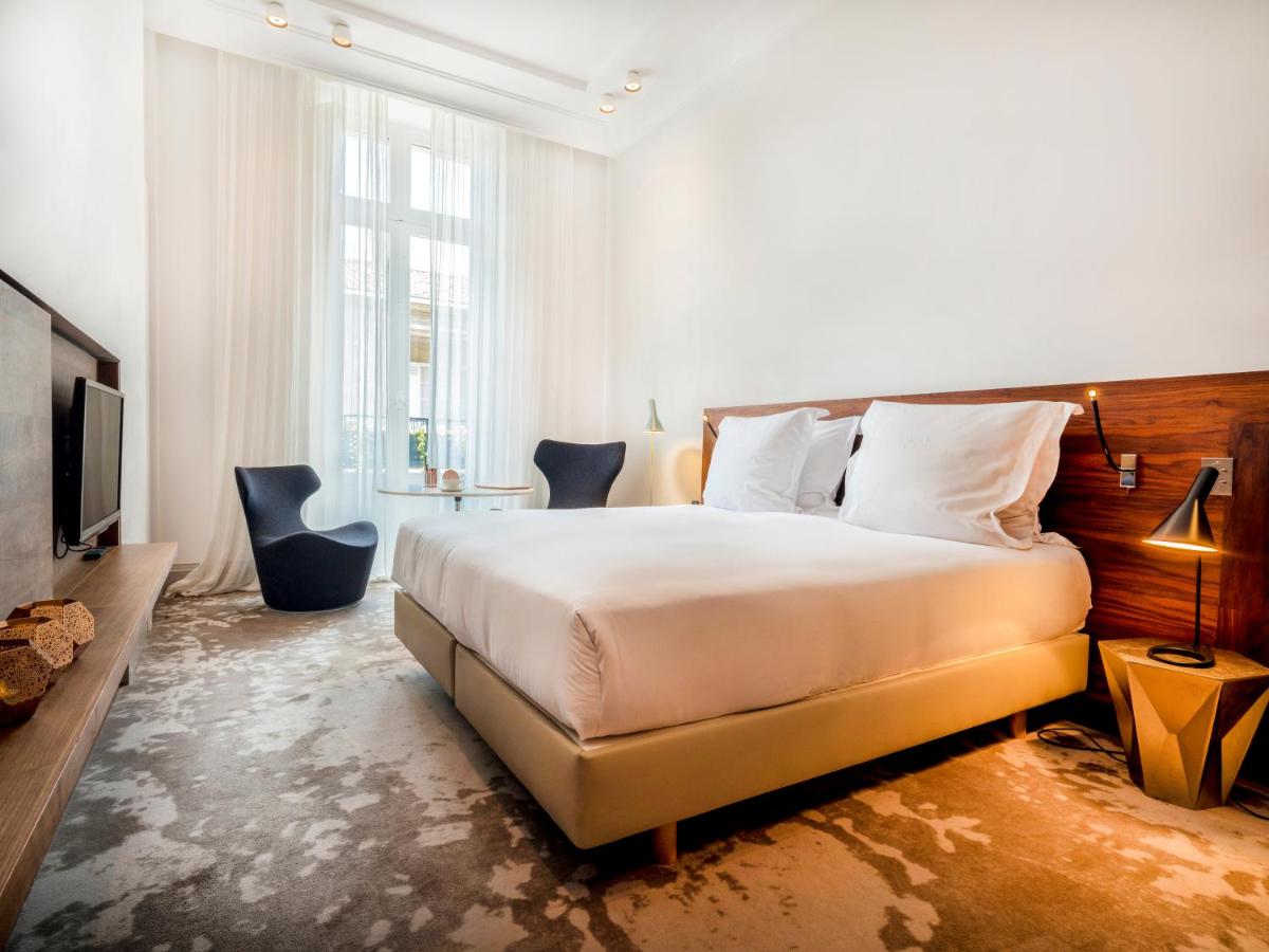 Un ou plusieurs lits dans un hébergement de l'établissement Yndo Hôtel