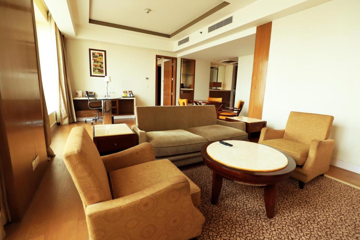 a living room with a couch and chairs and a table at Crowne Plaza New Delhi Okhla by IHG in New Delhi