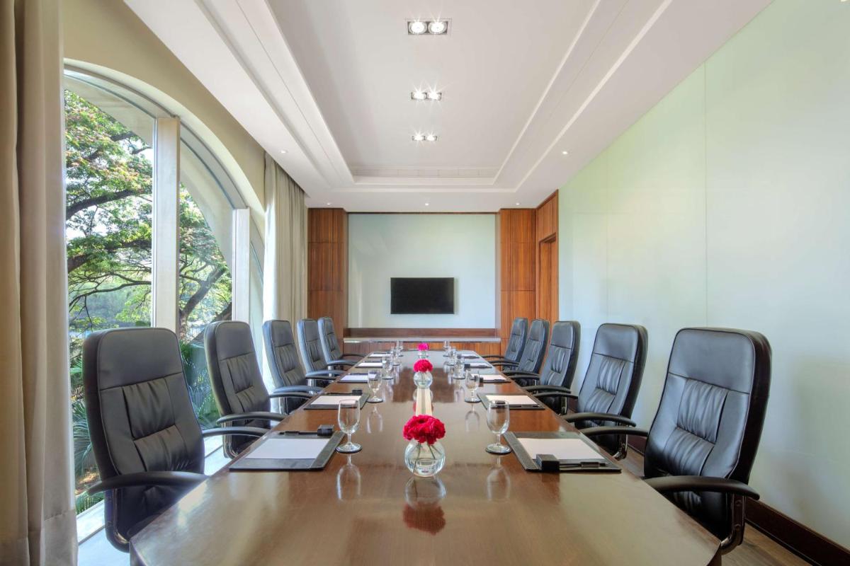 a large conference room with a long table and chairs at Radisson Blu Plaza Hotel Mysore in Mysore
