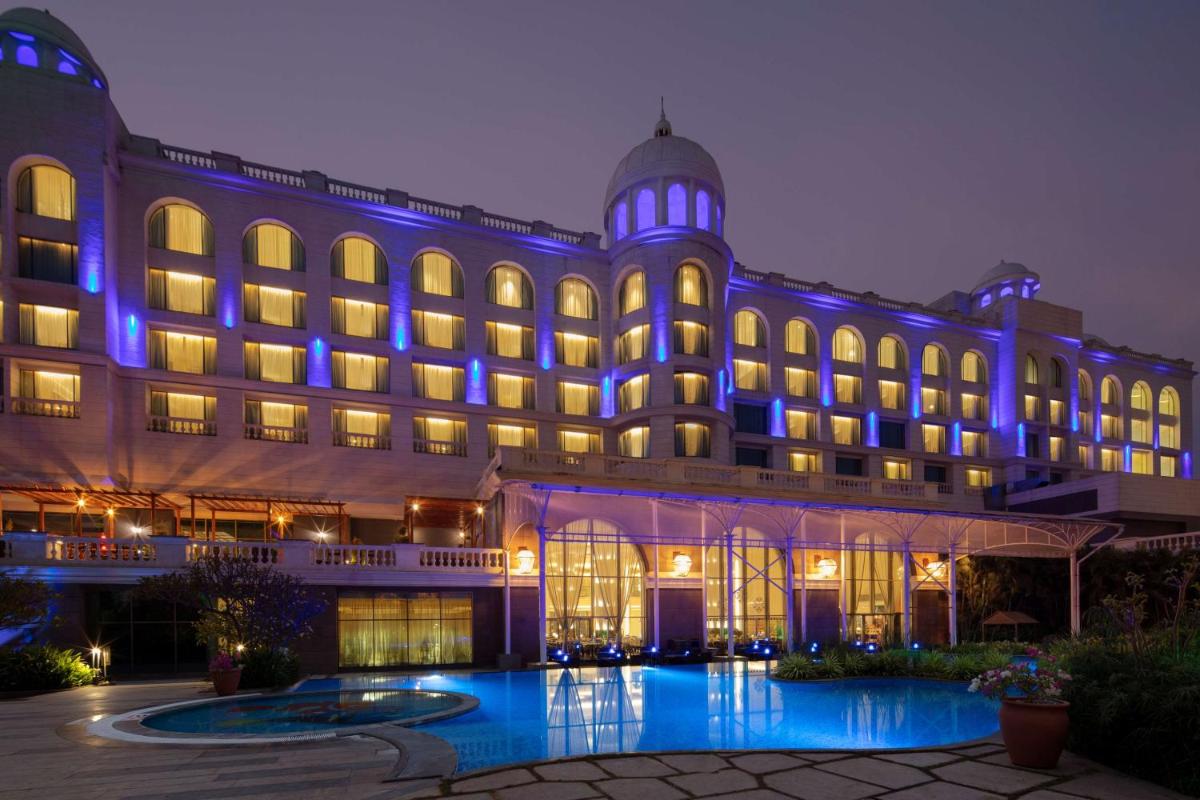 a large building with blue lights on it at Radisson Blu Plaza Hotel Mysore in Mysore