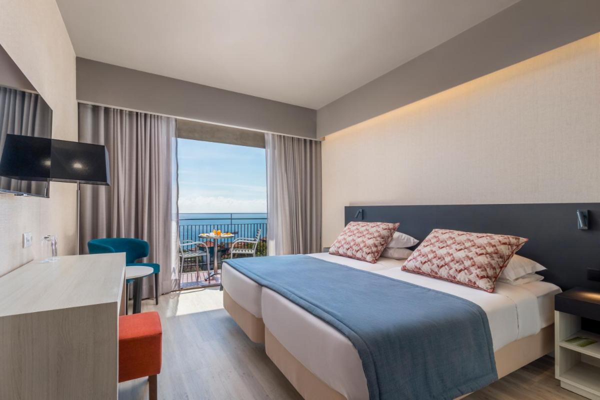 Uma cama ou camas num quarto em Enotel Magnólia