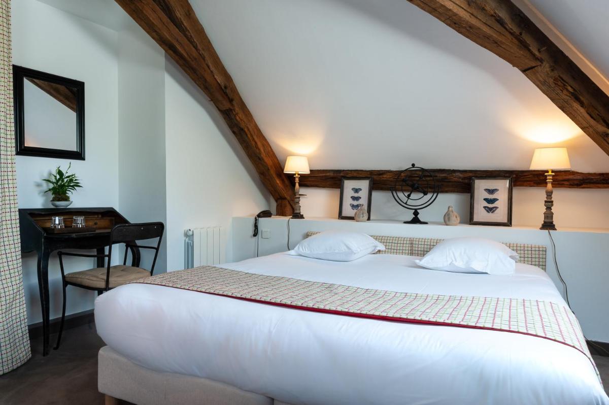 Un ou plusieurs lits dans un hébergement de l'établissement Château de Courban and Spa Nuxe
