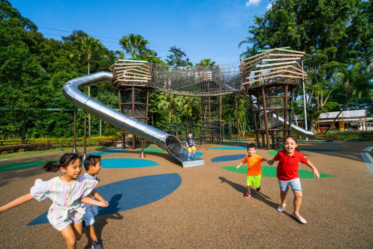 a group of children playing at a playground at Shangri-La Rasa Sentosa, Singapore in Singapore