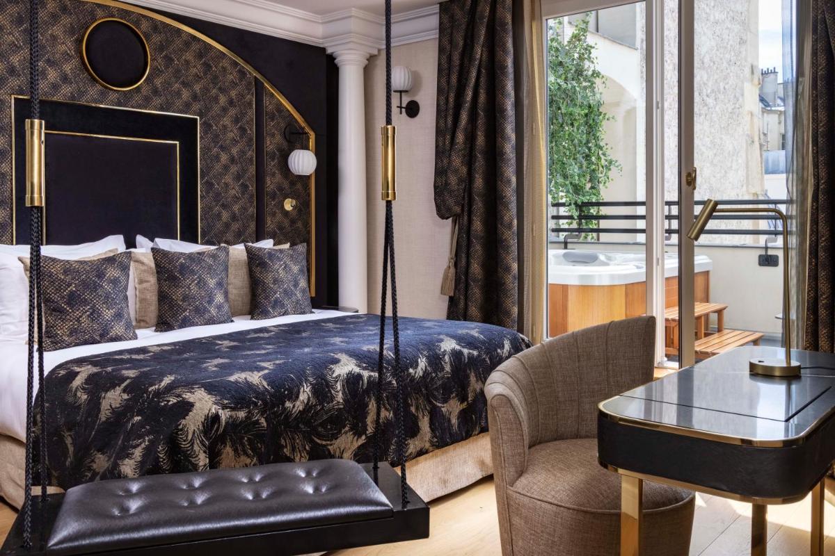 Un ou plusieurs lits dans un hébergement de l'établissement Paris j'Adore Hotel & Spa