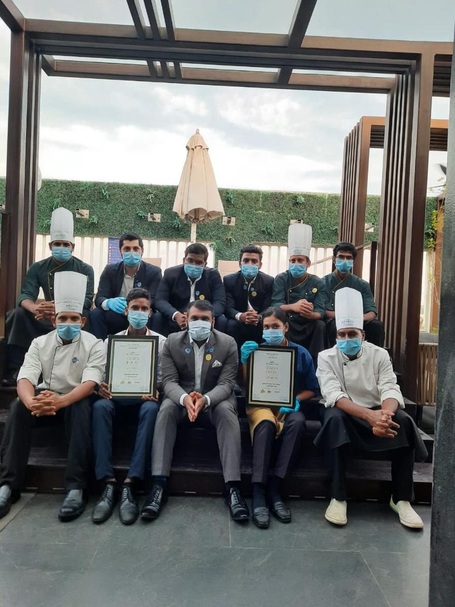 a group of men posing for a picture with their certificates at Novotel Chennai Chamiers Road in Chennai