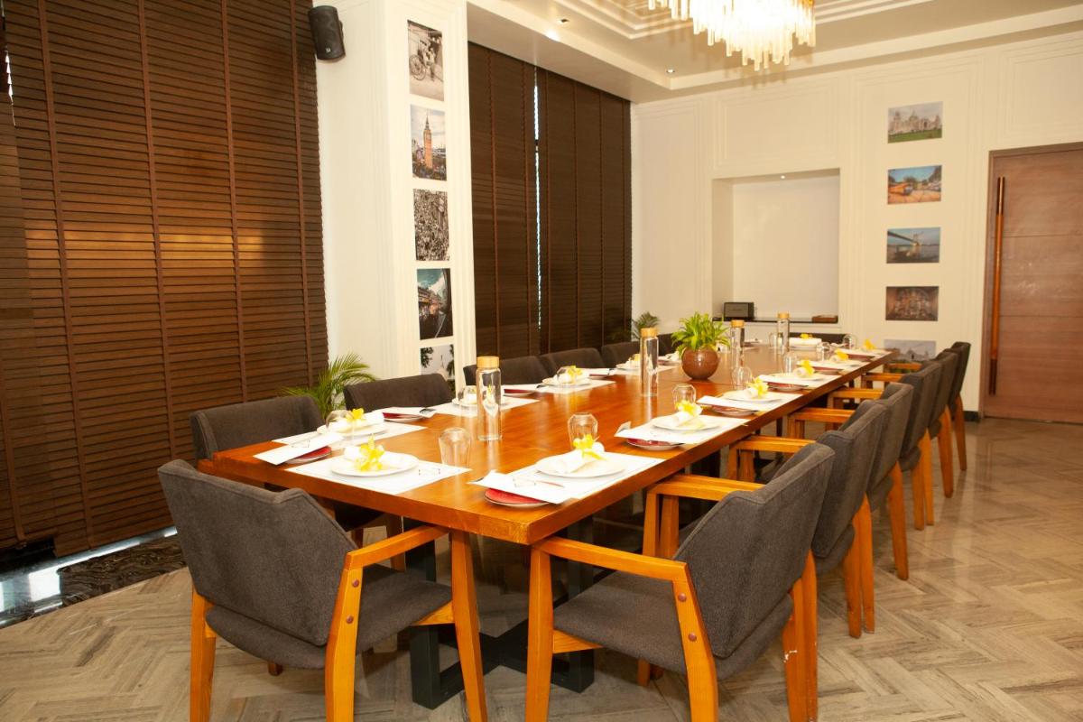 a large conference room with a long table and chairs at Novotel Chennai Chamiers Road in Chennai