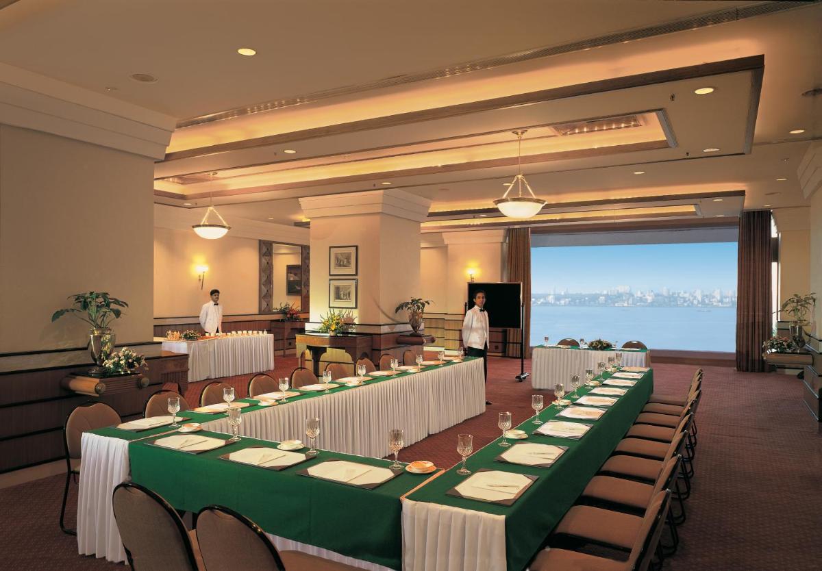 a banquet hall with long tables and chairs and people at Trident Nariman Point in Mumbai +107 photos a banquet hall with long tables and chairs and people at Trident Nariman Point in Mumbai +107 photos