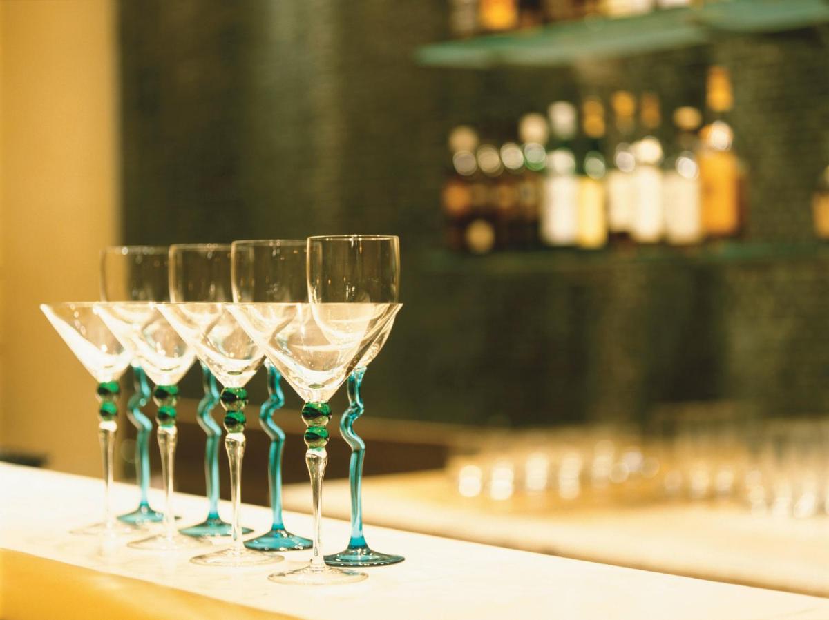 a row of wine glasses sitting on a counter at Trident Nariman Point in Mumbai a row of wine glasses sitting on a counter at Trident Nariman Point in Mumbai