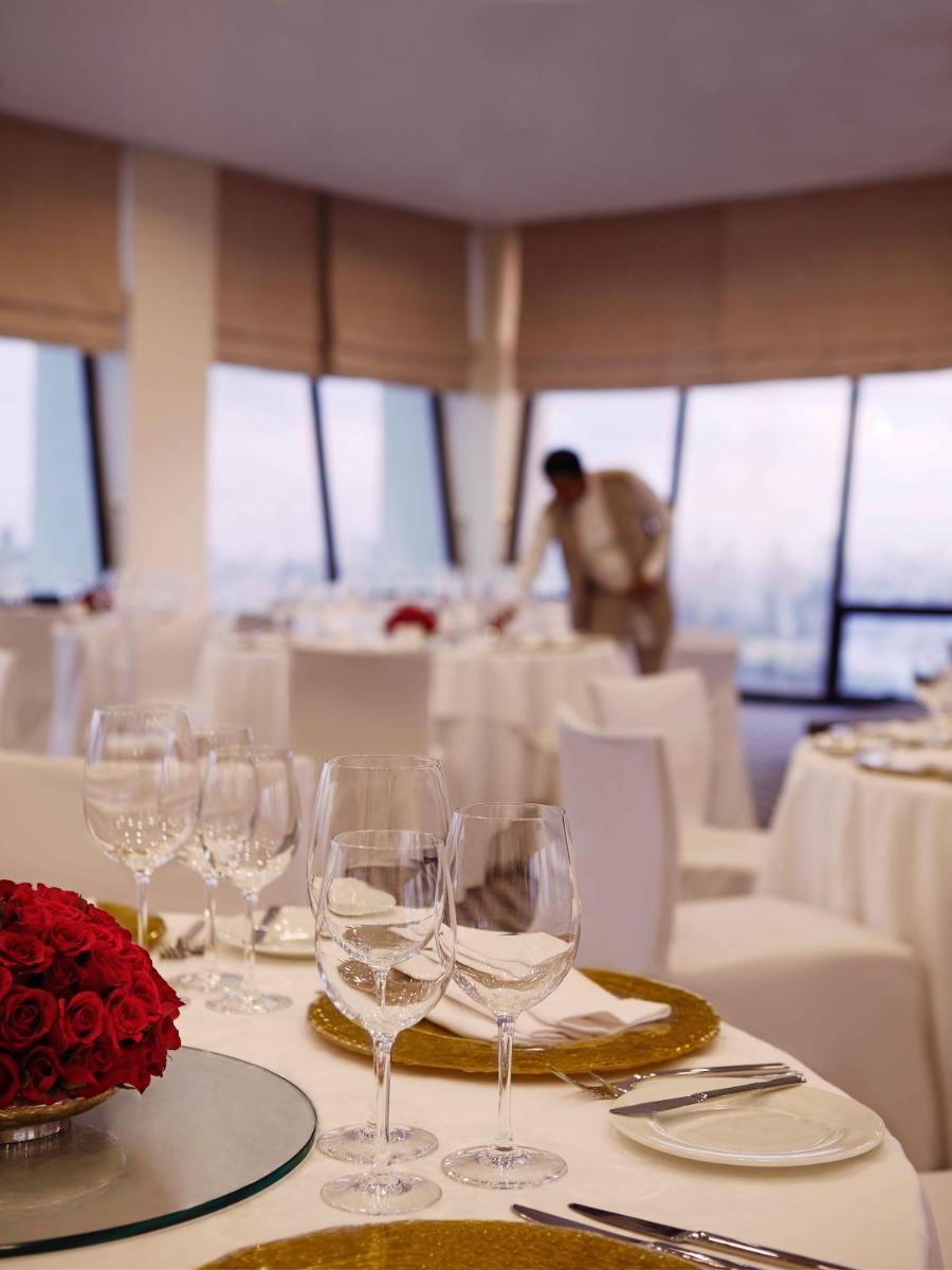 a table with wine glasses on top of a boat at Trident Nariman Point in Mumbai a table with wine glasses on top of a boat at Trident Nariman Point in Mumbai