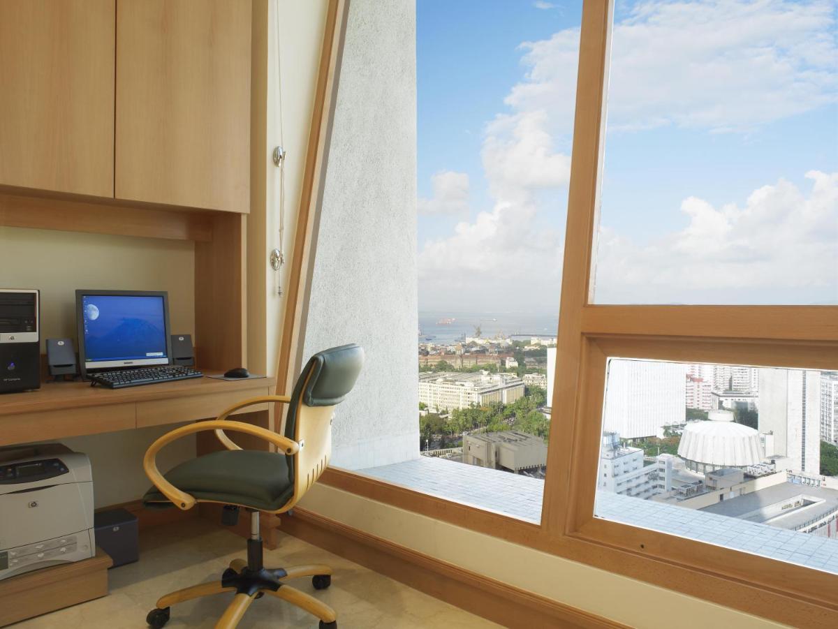 an office with a desk and a computer and a window at Trident Nariman Point in Mumbai an office with a desk and a computer and a window at Trident Nariman Point in Mumbai