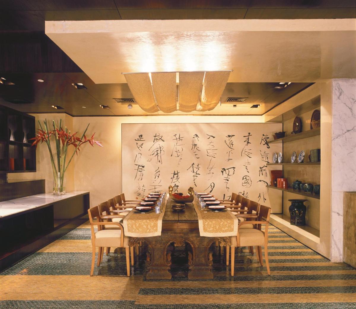 a dining room with a long table and chairs at Trident Nariman Point in Mumbai a dining room with a long table and chairs at Trident Nariman Point in Mumbai