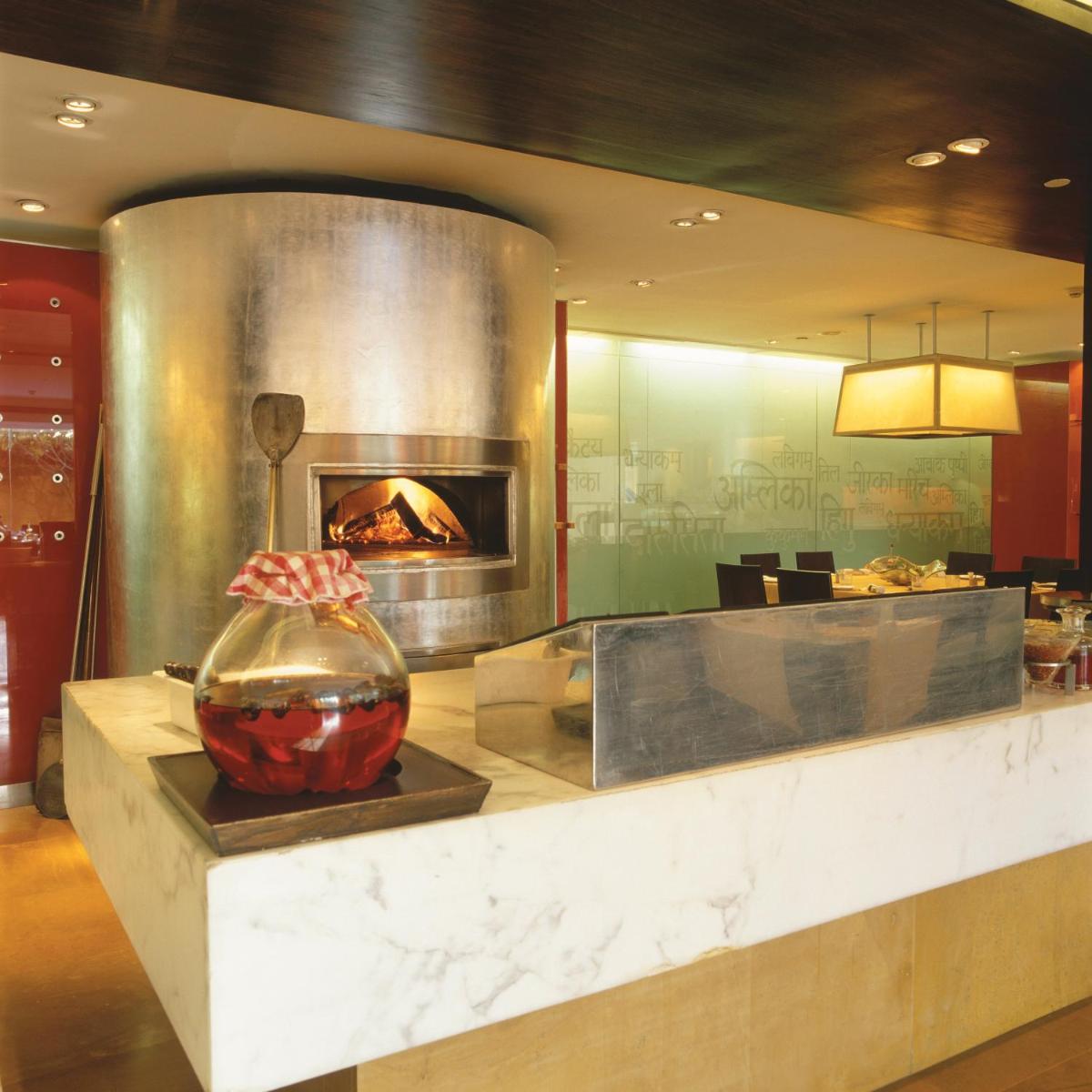 a lobby with a fireplace in a restaurant at Trident Nariman Point in Mumbai a lobby with a fireplace in a restaurant at Trident Nariman Point in Mumbai