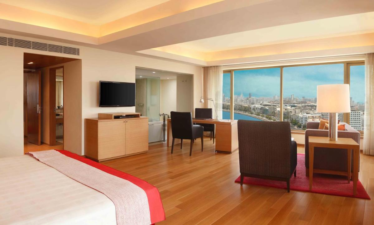 a hotel room with a bed and a view of the city at Trident Nariman Point in Mumbai a hotel room with a bed and a view of the city at Trident Nariman Point in Mumbai