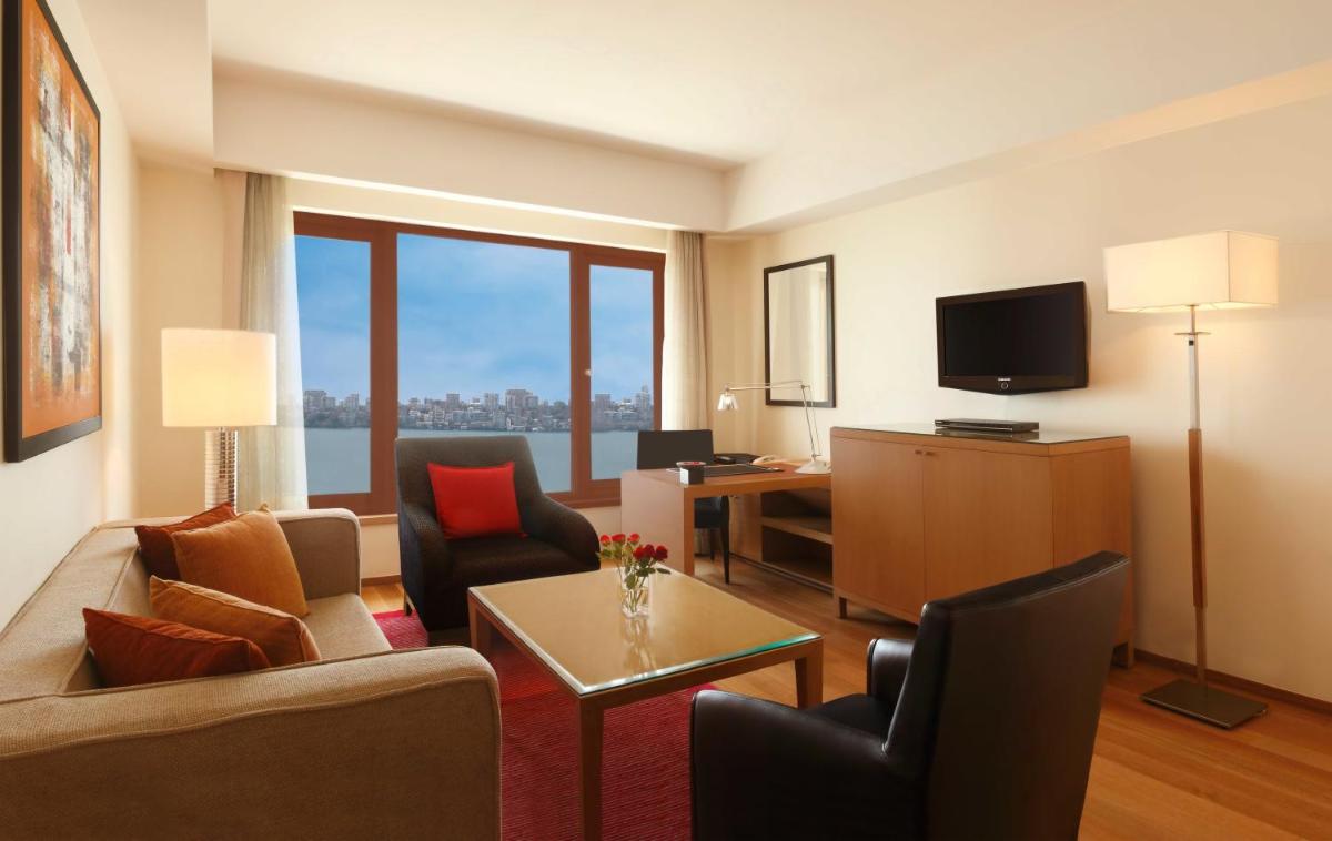 a living room with a couch and a table at Trident Nariman Point in Mumbai a living room with a couch and a table at Trident Nariman Point in Mumbai