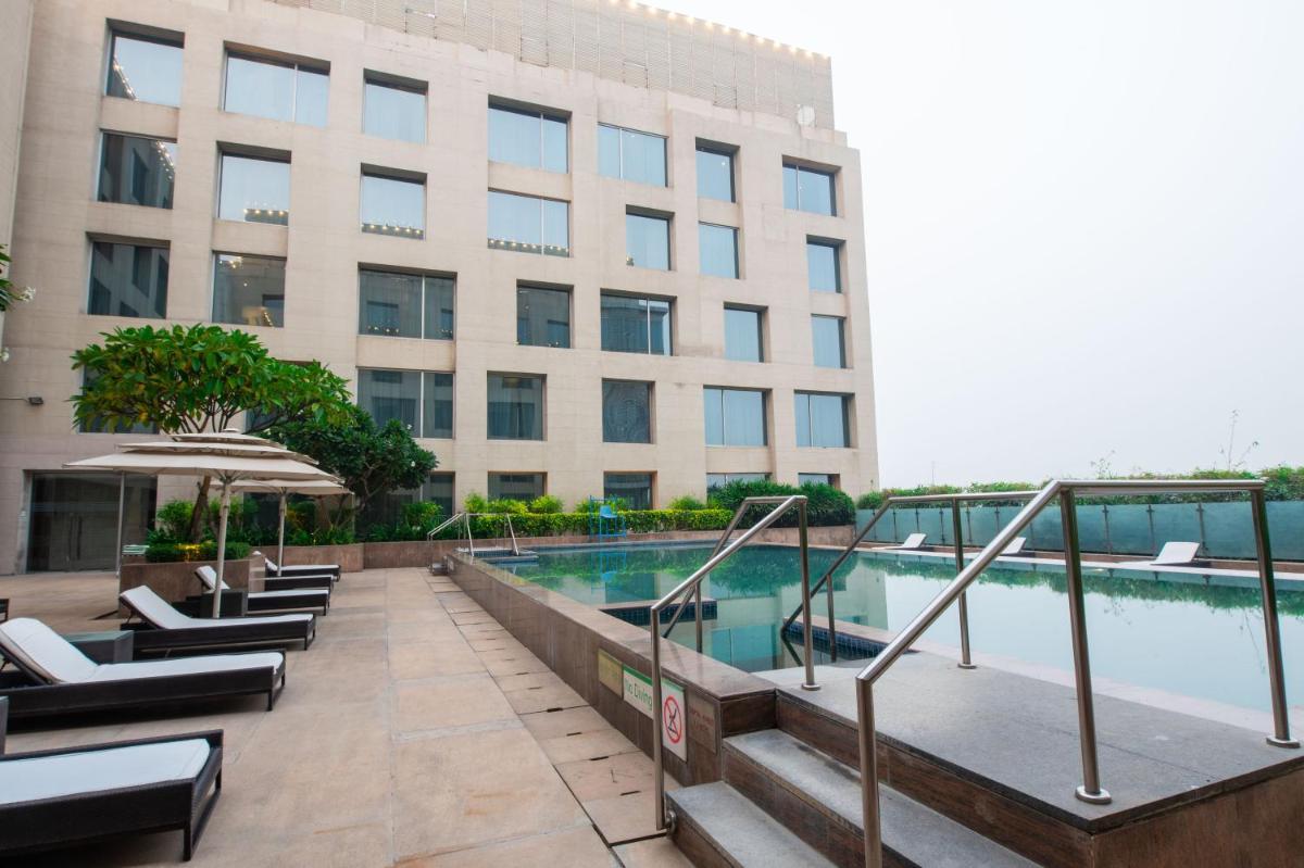 a hotel with a swimming pool in front of a building at Holiday Inn New Delhi Aerocity by IHG in New Delhi