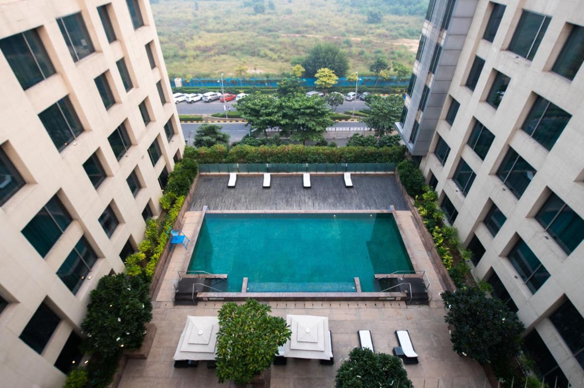 an overhead view of a swimming pool between two buildings at Holiday Inn New Delhi Aerocity by IHG in New Delhi