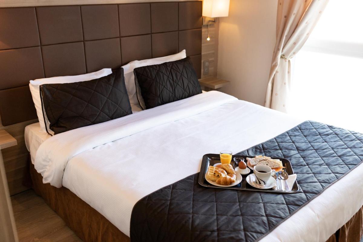 Un ou plusieurs lits dans un hébergement de l'établissement Hotel Regina & Spa