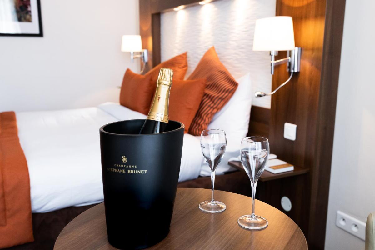 Un ou plusieurs lits dans un hébergement de l'établissement Hotel Regina & Spa