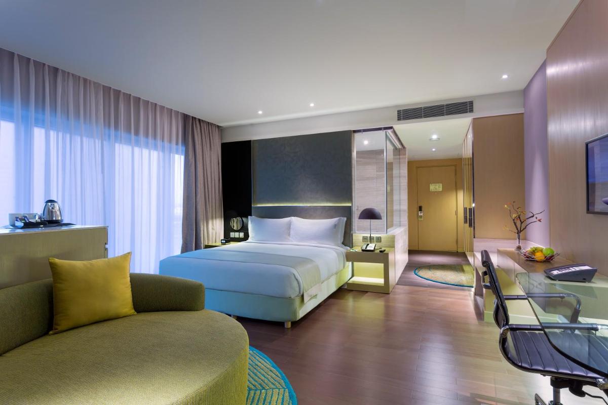 a hotel room with a bed and a couch at Holiday Inn New Delhi Aerocity by IHG in New Delhi