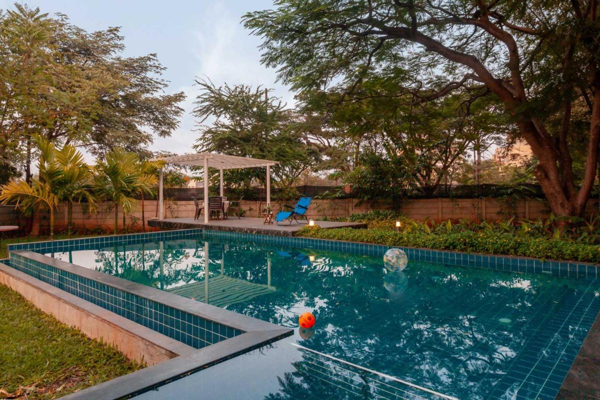 Morning Dew Retreat by StayVista - Modern interiors, Indoor games, Lush greenery, Pool & Gazebo await your escape - Housity