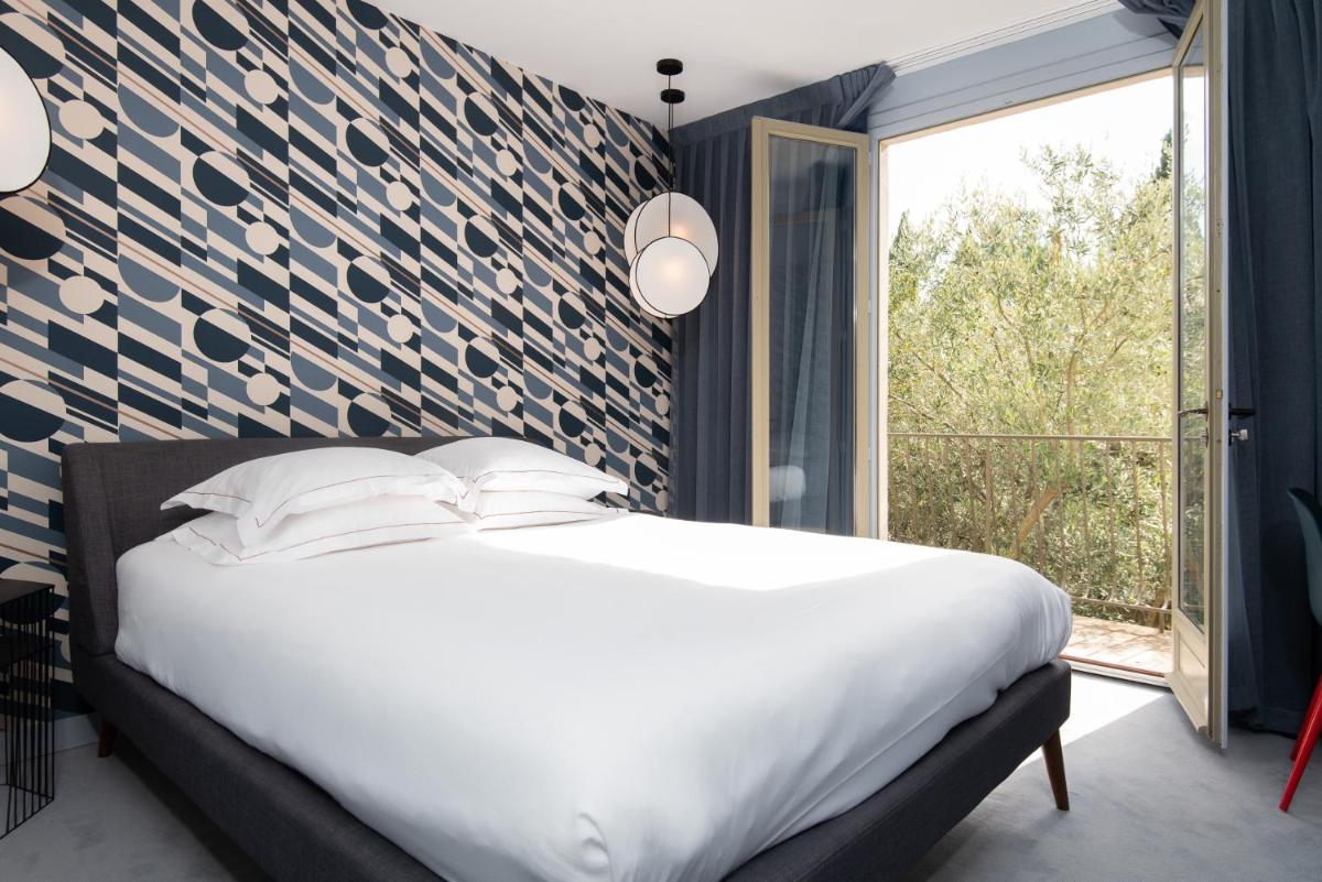 Un ou plusieurs lits dans un hébergement de l'établissement Hôtel Montmorency & Spa