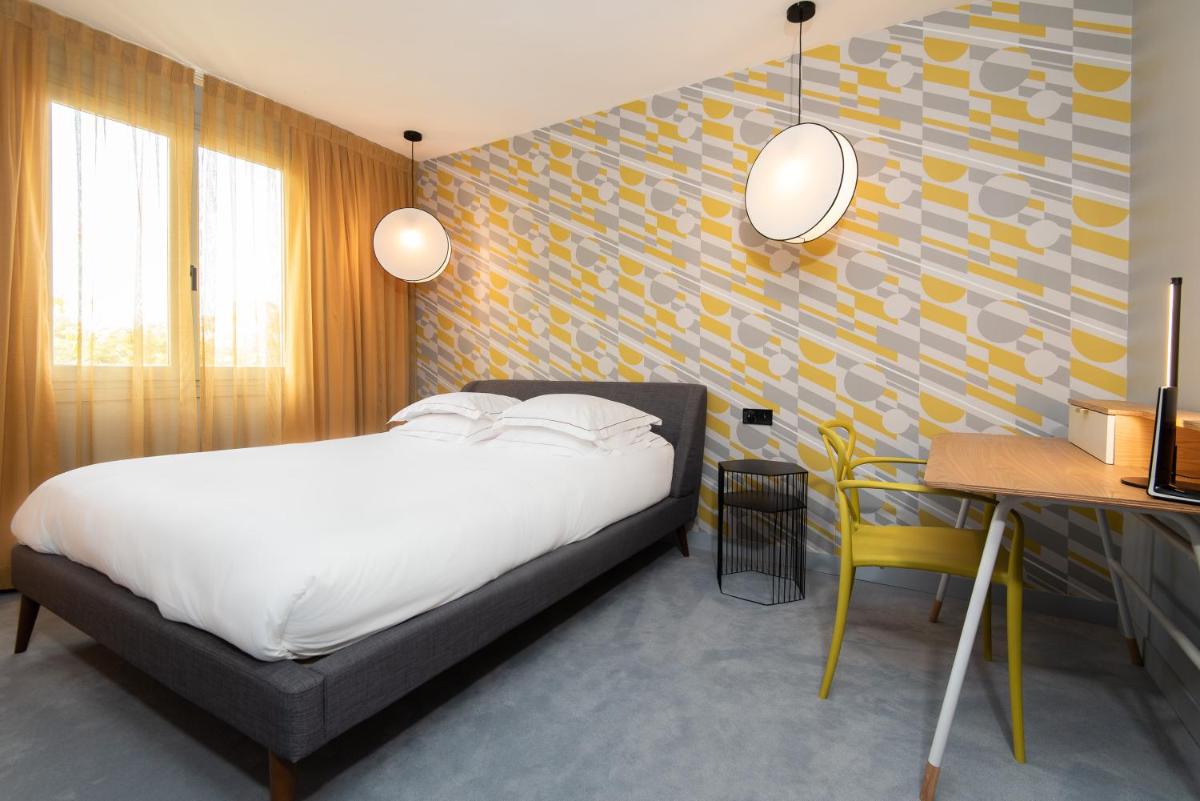 Un ou plusieurs lits dans un hébergement de l'établissement Hôtel Montmorency & Spa