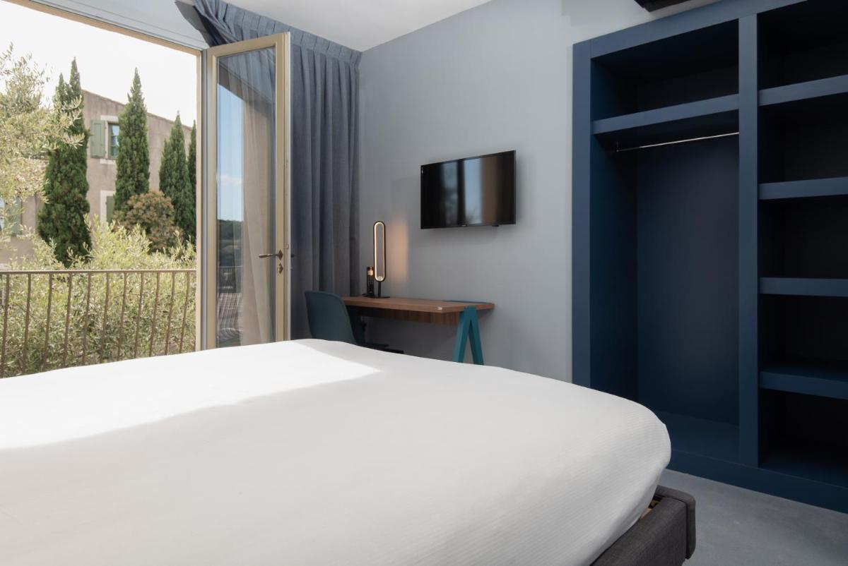 Un ou plusieurs lits dans un hébergement de l'établissement Hôtel Montmorency & Spa