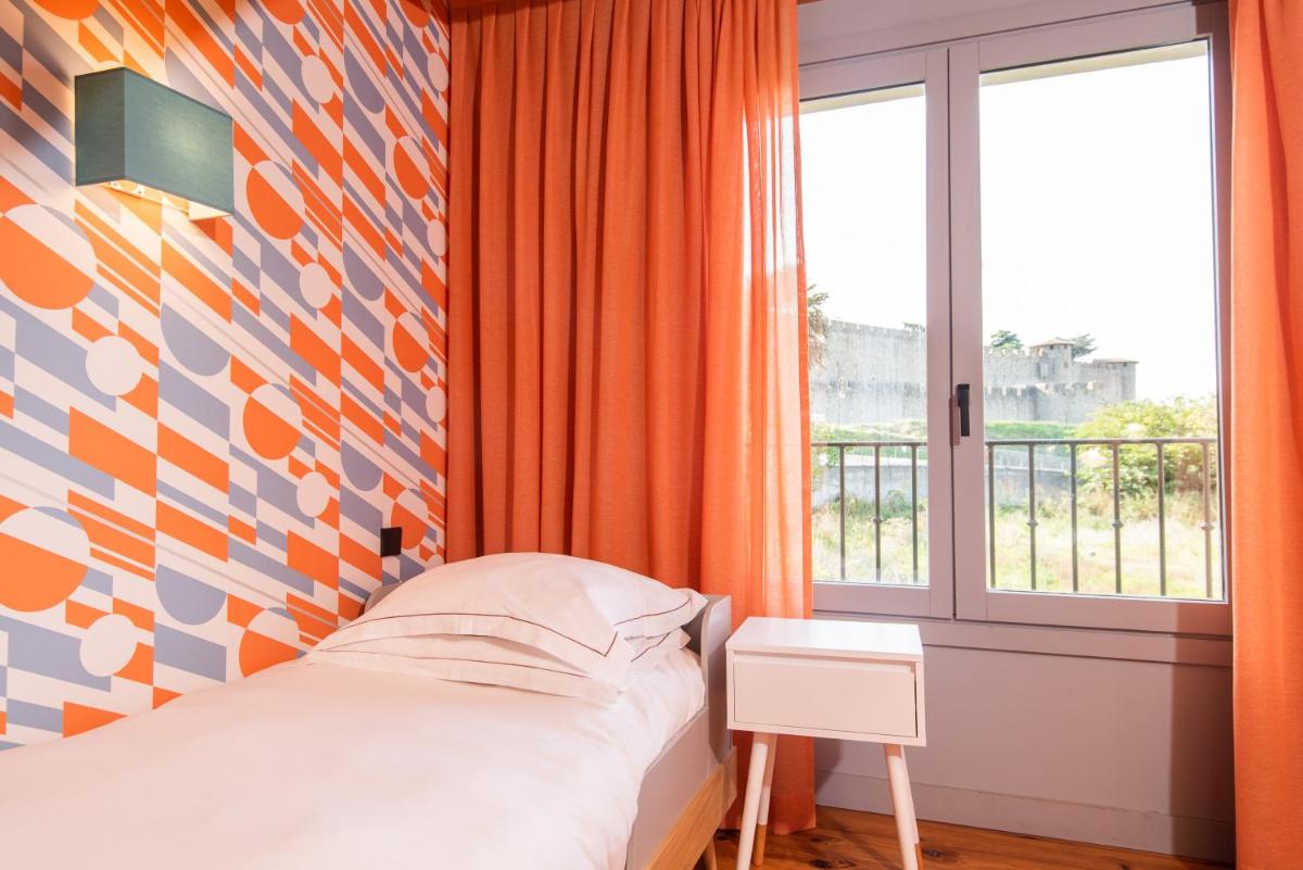 Un ou plusieurs lits dans un hébergement de l'établissement Hôtel Montmorency & Spa