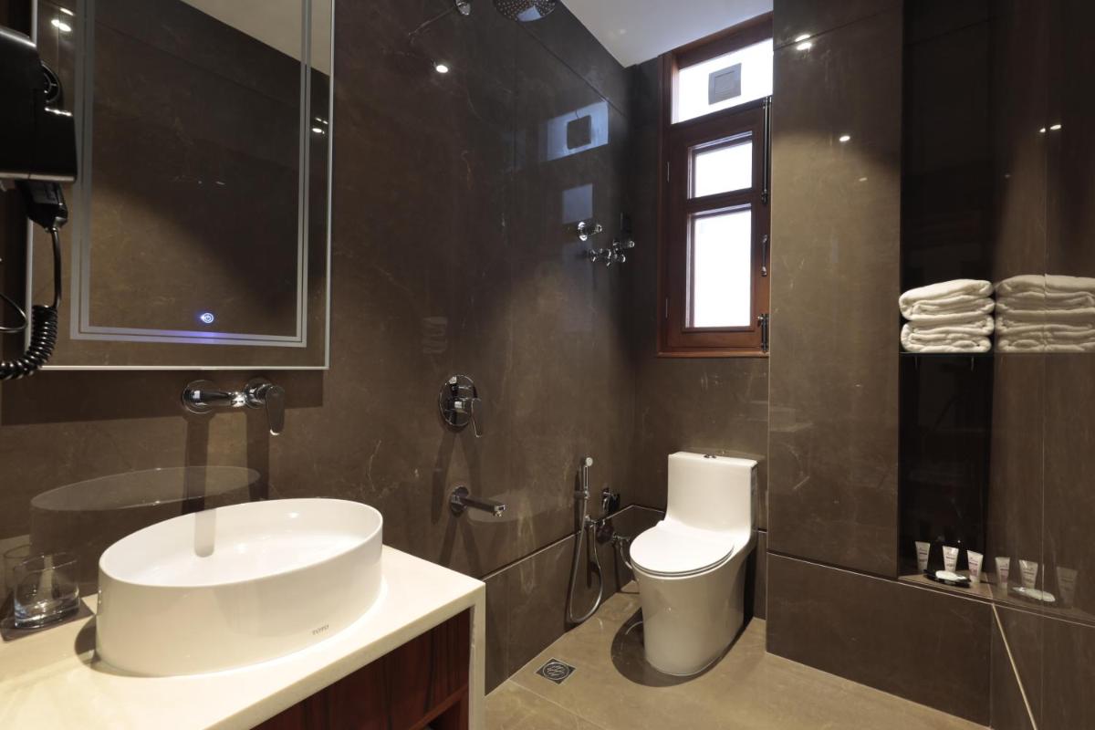 a bathroom with a sink and a toilet at WelcomHeritage Elysium Resort & Spa in Shimla