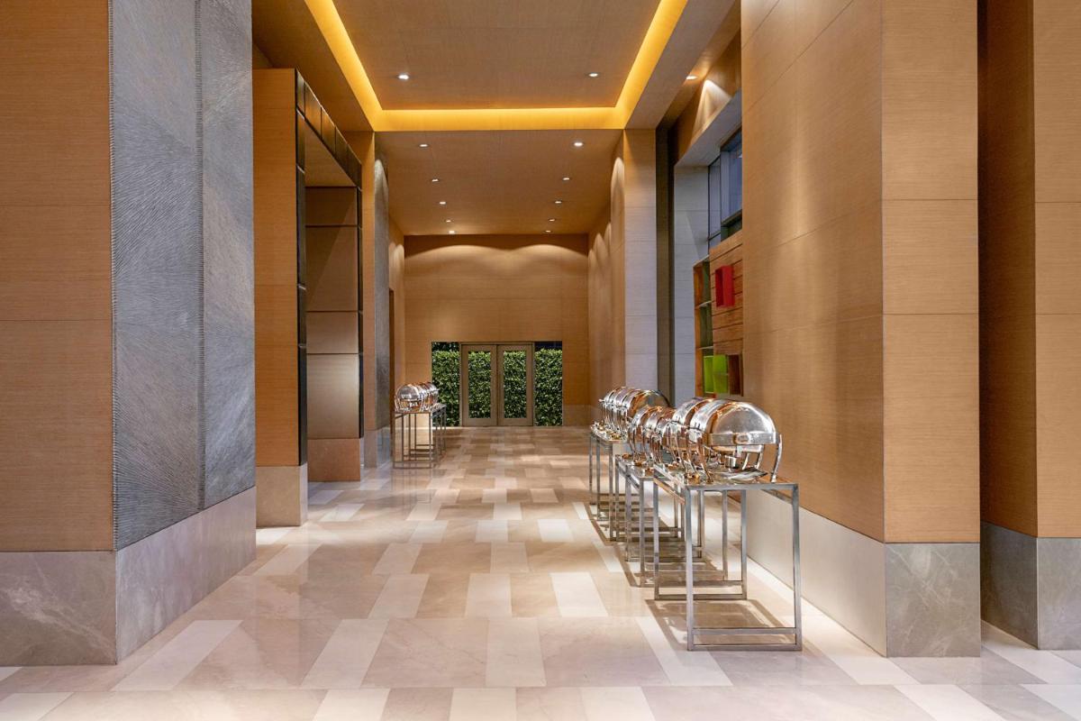 a hallway with a row of stools in a building at Radisson Blu Hotel Amritsar in Amritsar
