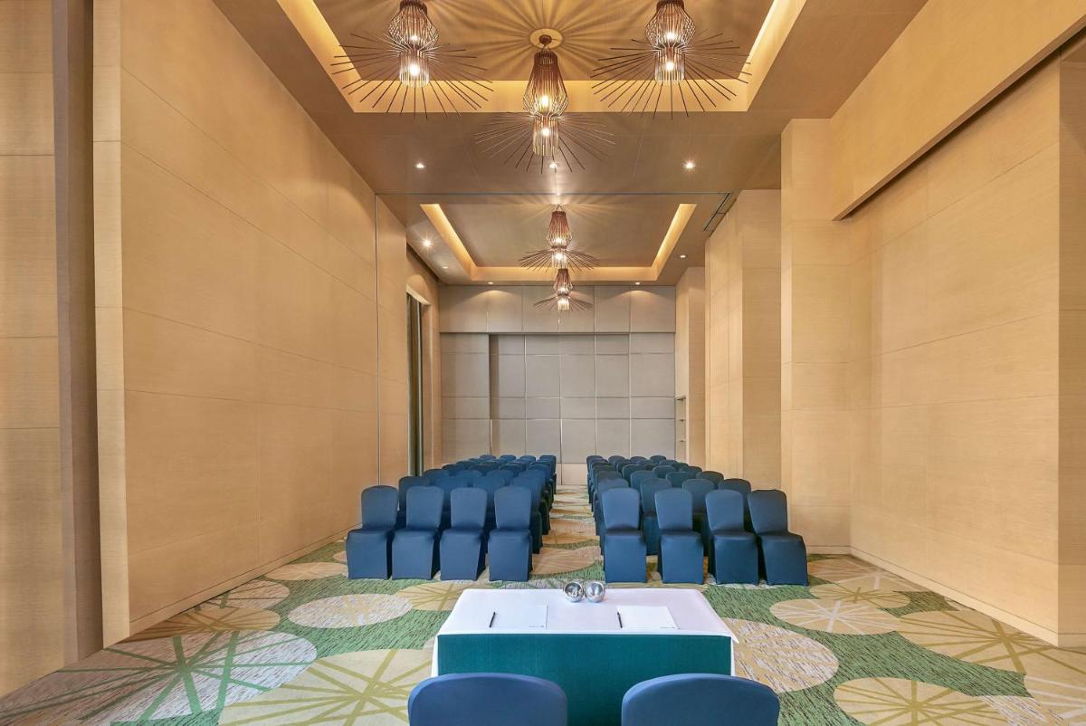 a conference room with blue chairs and a table at Radisson Blu Hotel Amritsar in Amritsar