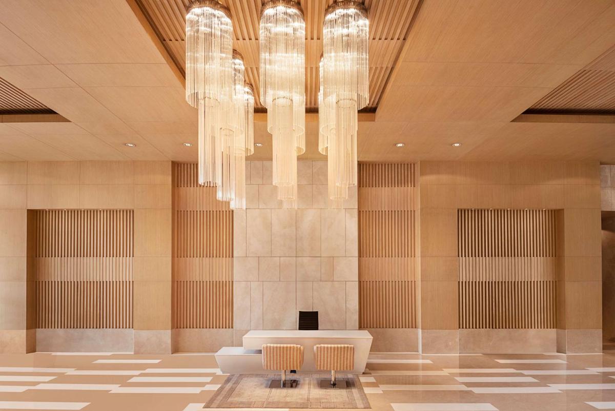a lobby with a chandelier and a couch and chairs at Radisson Blu Hotel Amritsar in Amritsar
