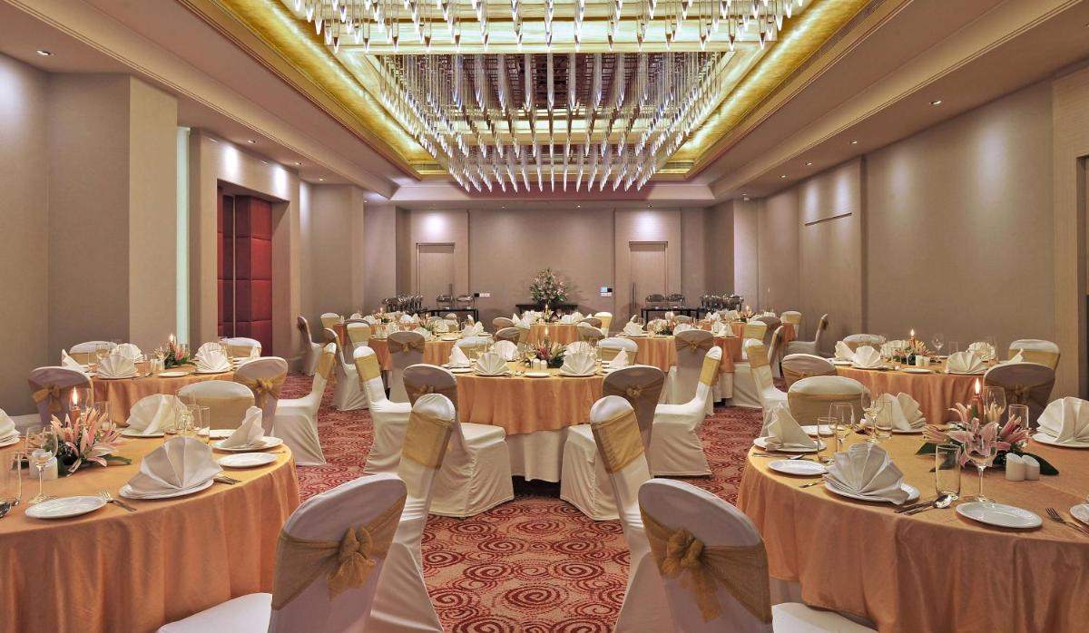 a banquet hall with tables and chairs in a room at Radisson Hyderabad Hitec City in Hyderabad +59 photos