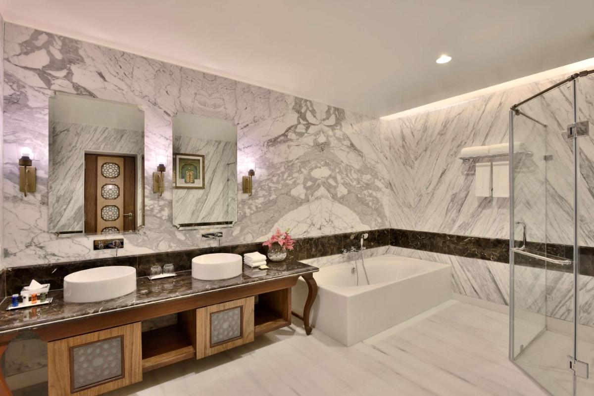 a bathroom with a tub and a sink and a bath tub at Radisson Jodhpur in Jodhpur