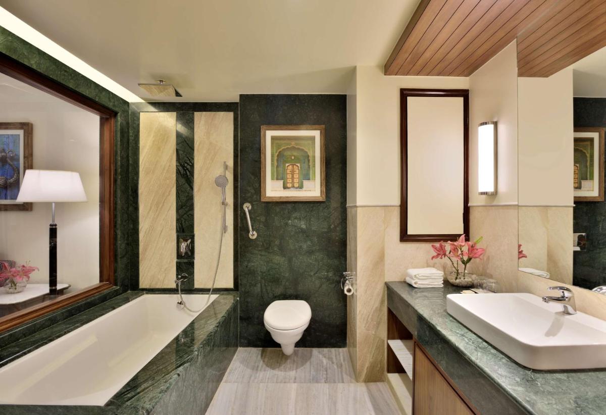 a bathroom with a tub and a toilet and a sink at Radisson Jodhpur in Jodhpur
